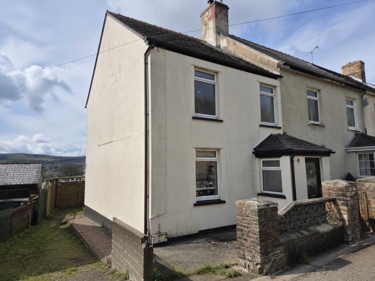 Example front elevation of a residential property used in the sample damp report overview